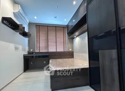 Modern bedroom with sleek design, built-in shelves, and air conditioning unit.