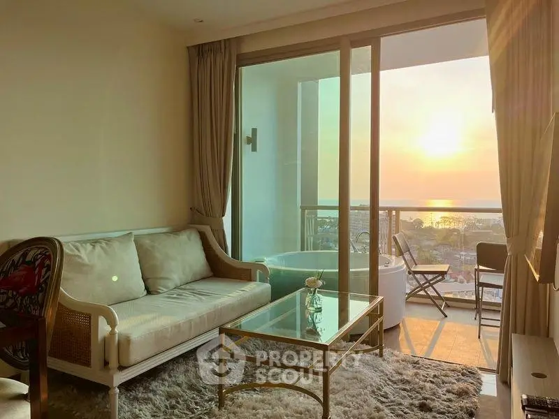 Charming living room with sunset view and cozy balcony seating.