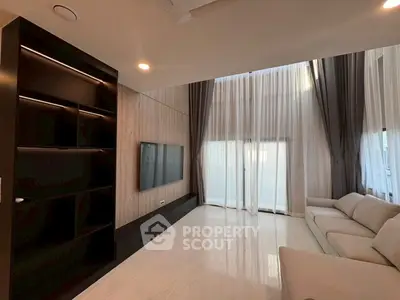 Luxurious modern living room with high ceilings and elegant curtains