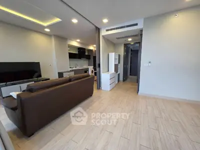 Modern living room with open kitchen and stylish furniture in a contemporary apartment