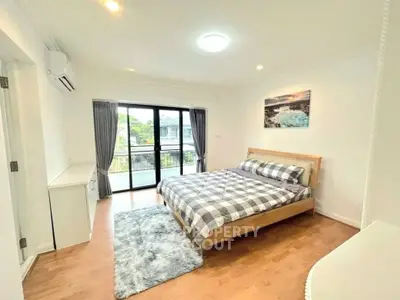 Spacious bedroom with modern decor and large window view