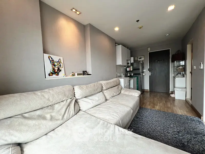 Modern living room with cozy beige sofa and stylish decor in a contemporary apartment.