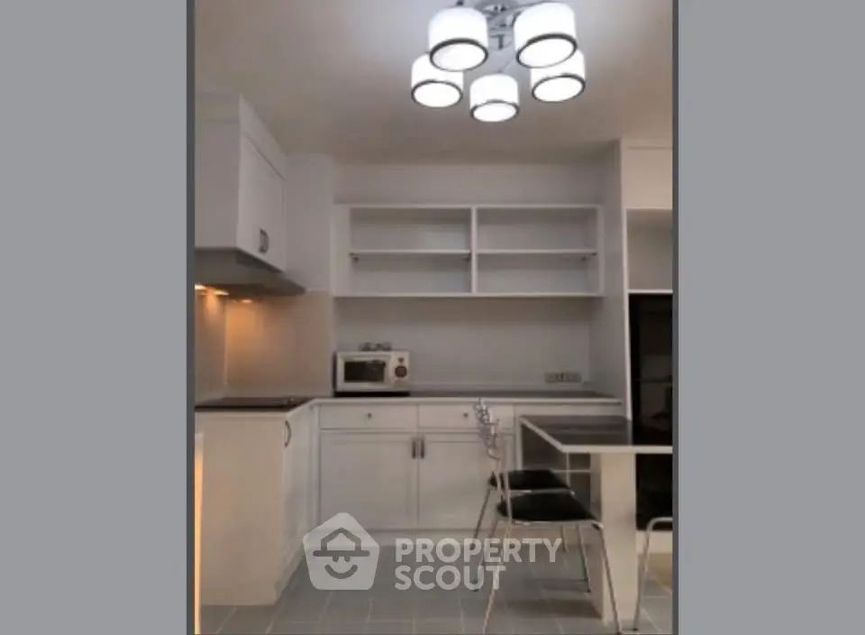 Modern kitchen with sleek white cabinetry and stylish lighting