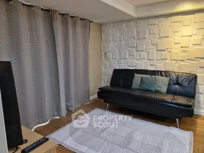 Modern living room with stylish wall design and cozy seating area.