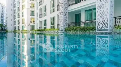 Luxurious apartment complex with stunning poolside view and modern architecture.