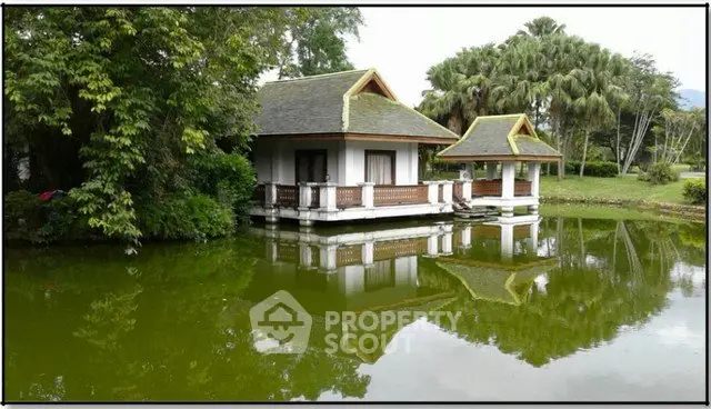 Charming lakeside house with traditional architecture and lush greenery, perfect for serene living.