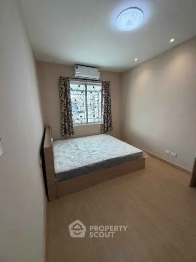 Cozy bedroom with natural light and modern air conditioning unit
