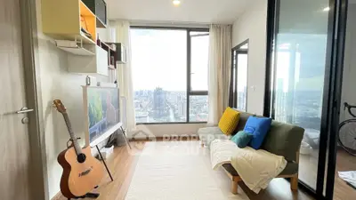 Modern living room with city view, stylish decor, and natural light.
