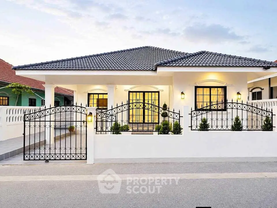 Charming single-story home with elegant iron gate and manicured garden, perfect for modern living.