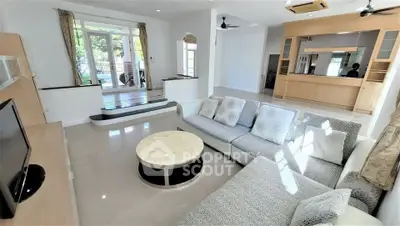 Spacious living room with modern furniture and large windows for natural light.