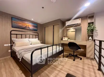 Modern bedroom with stylish decor and workspace, featuring a cozy bed and sleek furniture.