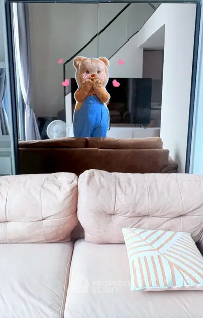 Cozy living room with plush sofa and stylish decor, perfect for relaxation and entertainment.