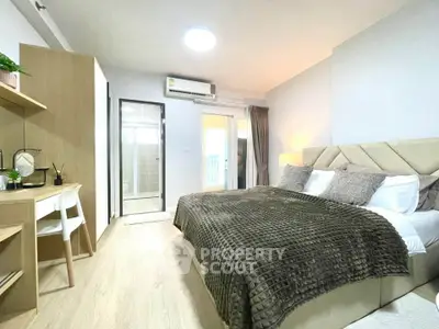 Spacious modern bedroom with elegant decor and natural light