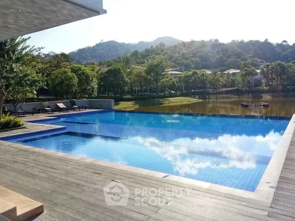 Luxurious outdoor pool with scenic mountain and lake view, perfect for relaxation and leisure.