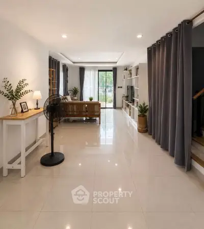 Spacious modern living room with elegant decor and large windows for natural light.