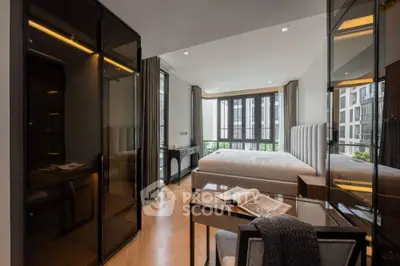 Luxurious modern bedroom with floor-to-ceiling windows and sleek furnishings.