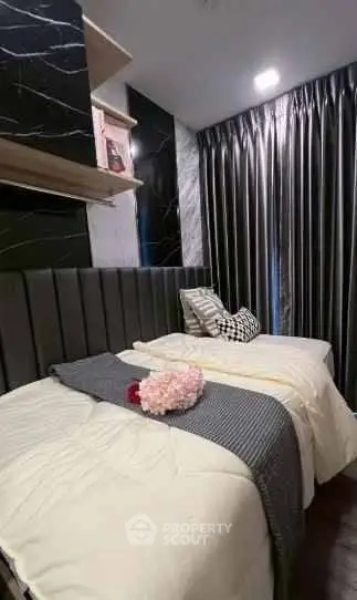 Luxurious bedroom with elegant decor and plush bedding in modern apartment.