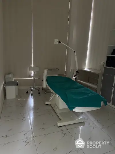 Modern medical examination room with sleek design and tiled flooring