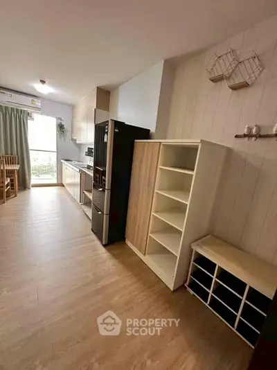 Modern kitchen with open layout and stylish dining area, featuring sleek appliances and ample storage space.