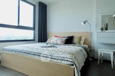 Modern bedroom with large window and stylish decor in urban apartment