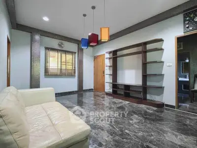 Spacious living room with modern decor and marble flooring