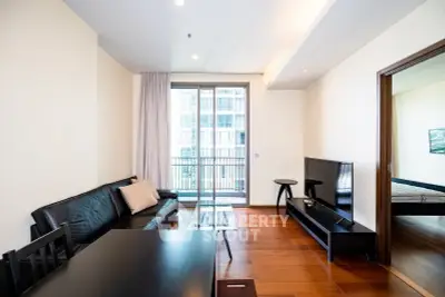Modern living room with sleek furniture and balcony view in a stylish apartment.