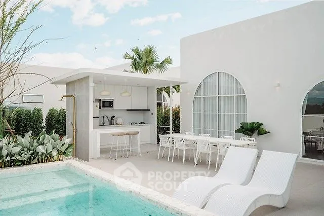 Luxurious outdoor pool area with modern dining and lounging setup, perfect for relaxation and entertainment.