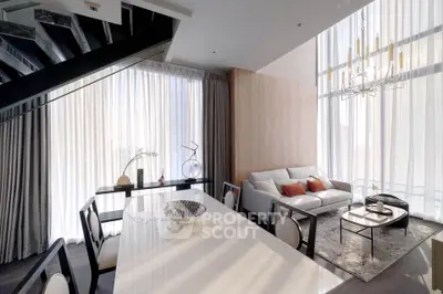 Luxurious modern living room with high ceilings and elegant decor, featuring a stylish dining area and large windows.