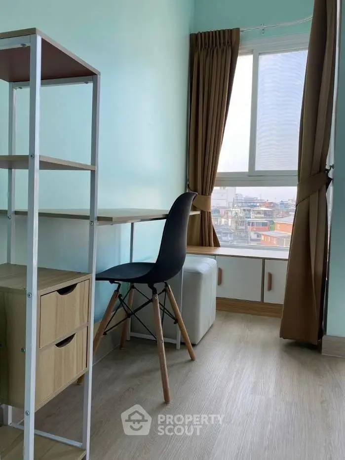 Bright study room with city view, modern desk and chair, ideal for productivity.