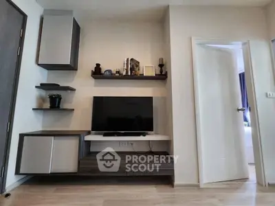 Modern living room with sleek TV unit and stylish shelving in a contemporary apartment.
