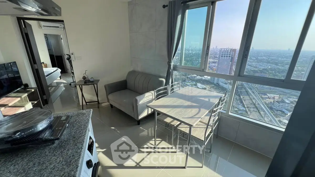 Modern apartment with panoramic city view, featuring cozy living area and sleek kitchen.