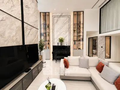 Luxurious modern living room with high ceilings, elegant marble accents, and stylish furniture.