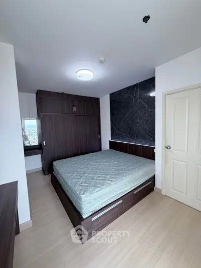 Modern bedroom with stylish dark wood furniture and elegant wall design
