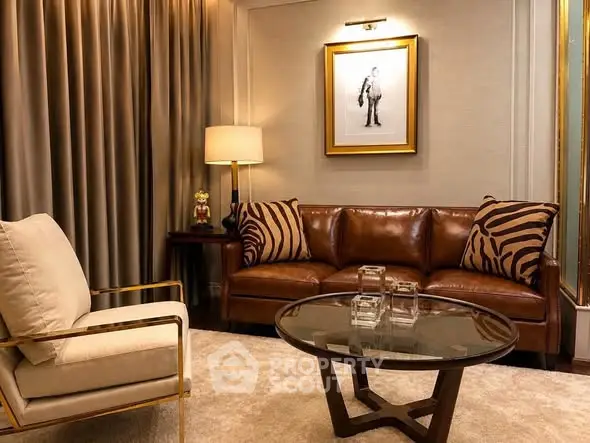 Luxurious living room with leather sofa, elegant armchair, and stylish decor in a modern apartment.