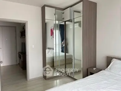 Modern bedroom with mirrored wardrobe and sleek design