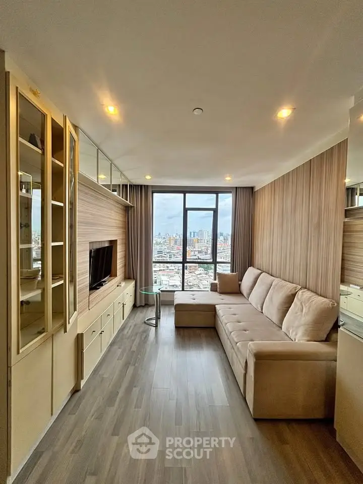 Modern living room with city view, featuring sleek design and comfortable seating.