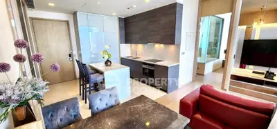 Modern open-layout kitchen and living area with stylish furniture and sleek design.