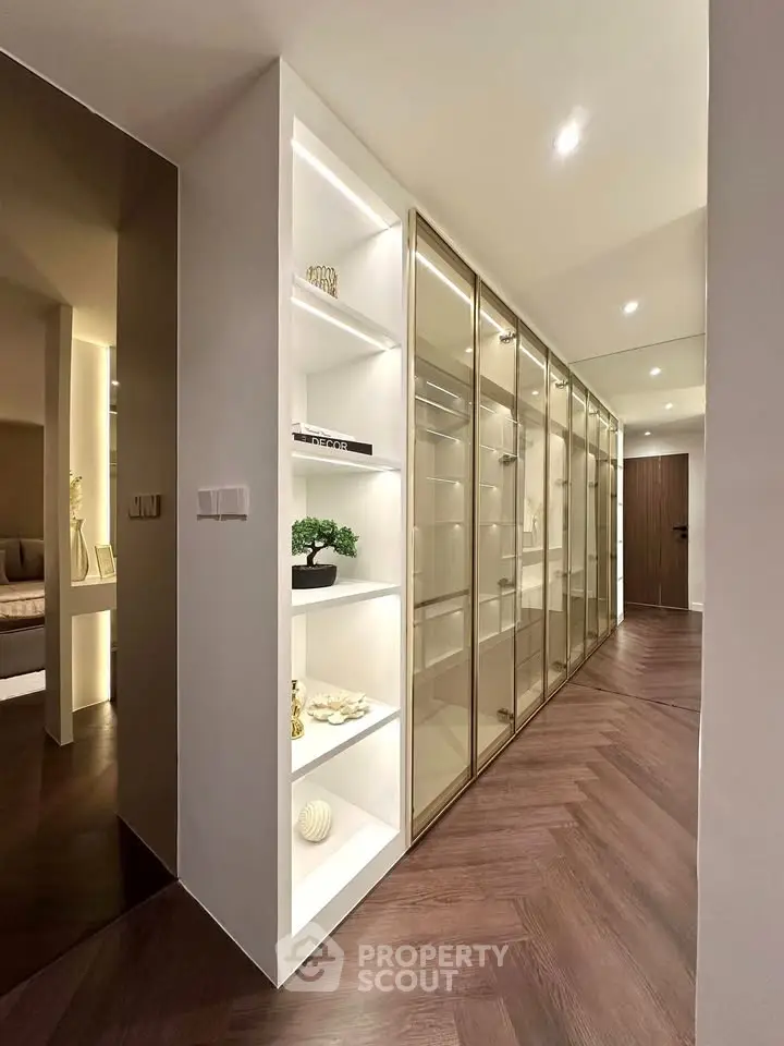 Luxurious hallway with elegant shelving and glass-fronted storage in modern apartment