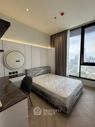 Modern bedroom with large window offering stunning city view, featuring a sleek design and contemporary furnishings.