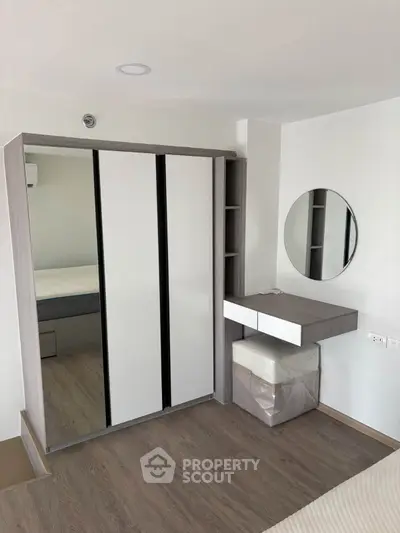 Modern bedroom with sleek wardrobe and stylish vanity mirror