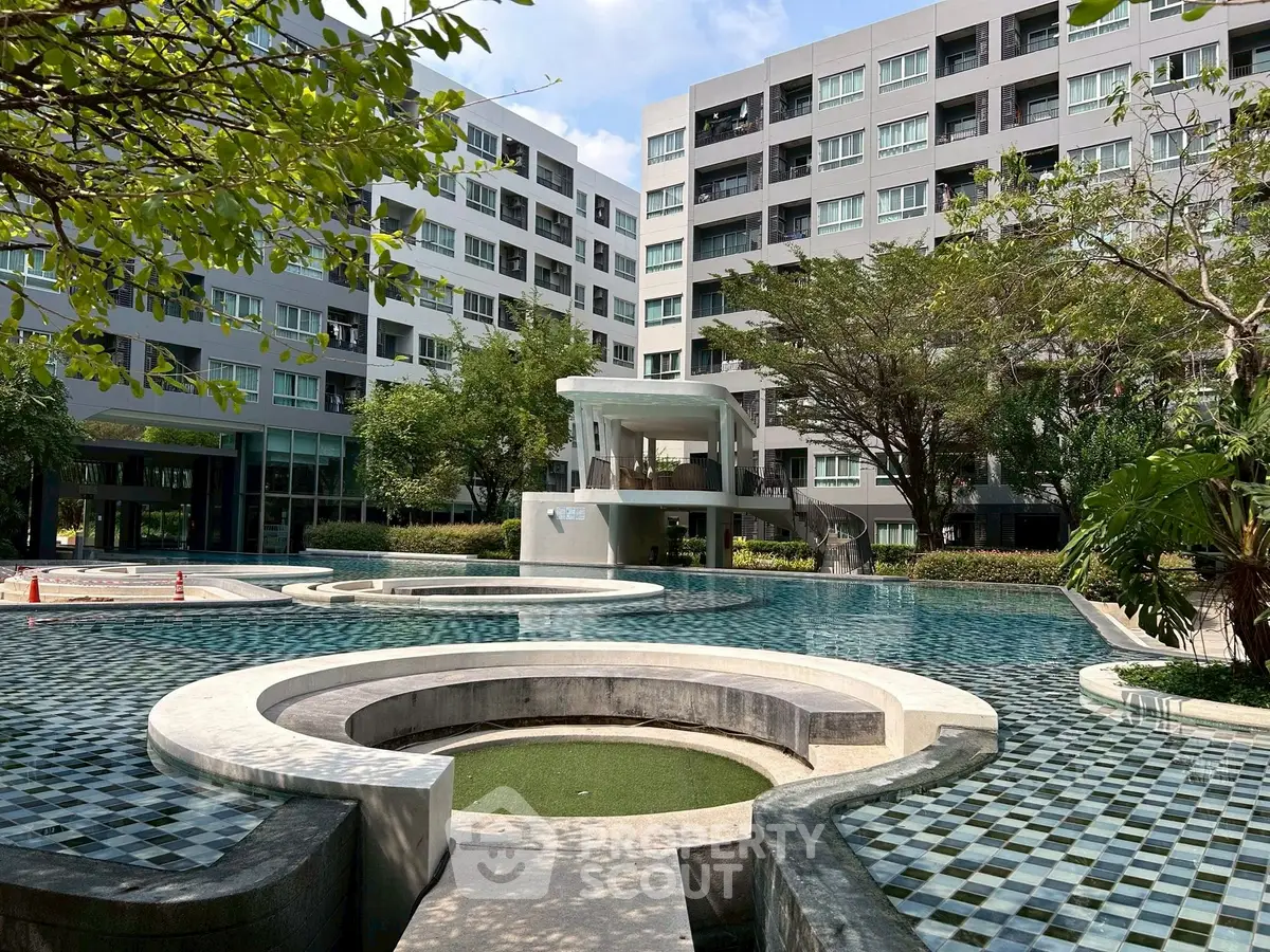 Modern apartment complex with a stunning pool and lush greenery