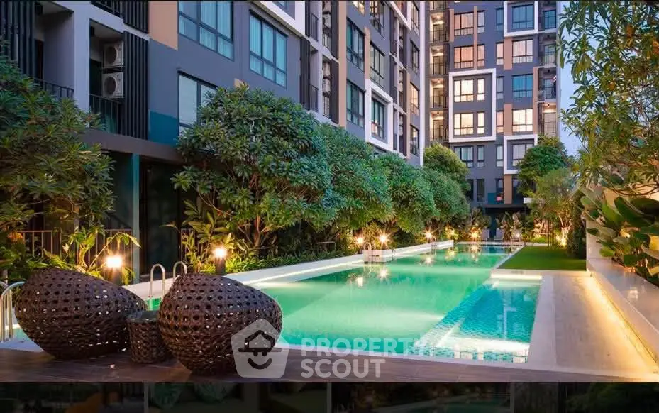 Luxurious condominium with a stunning outdoor pool and lush greenery, perfect for relaxation and leisure.