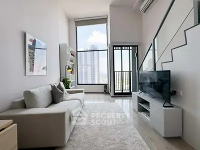 Modern living room with high ceilings and city view, featuring sleek furniture and large windows.