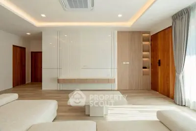 Modern living room with elegant design, featuring a spacious layout, neutral tones, and stylish lighting.