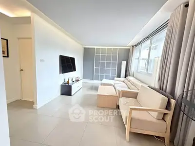 Spacious modern living room with sleek furniture and large windows for natural light.