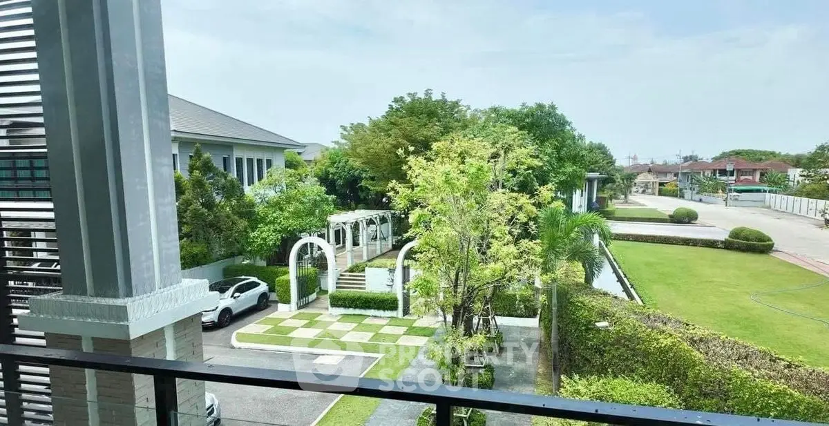 Stunning garden view from a modern balcony in a luxury residential area.