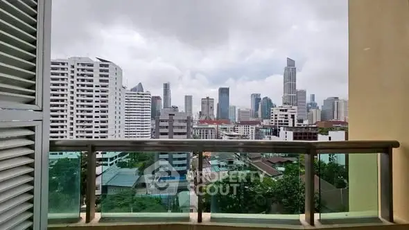 Stunning cityscape view from a modern balcony in a high-rise apartment.