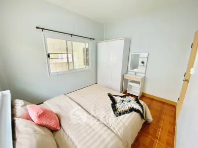 Cozy bedroom with stylish decor and ample natural light