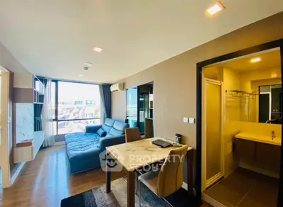 Modern living room with open layout and city view, featuring a cozy sofa and dining area.