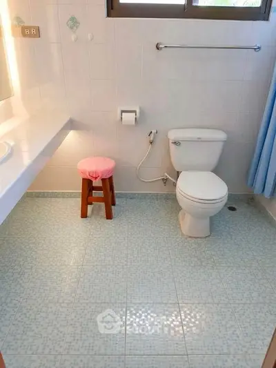 Bright and clean bathroom with modern fixtures and tiled flooring.